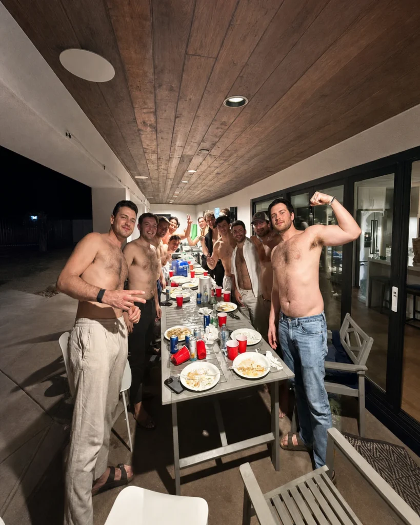 Friends gathered around an outdoor hibachi table at night