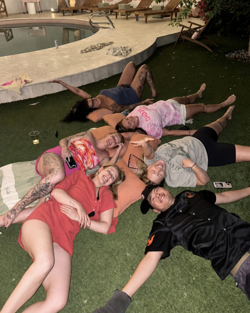 Guests posing together at a poolside lawn hibachi celebration