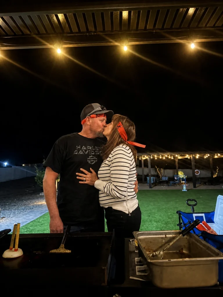 Couple sharing a kiss beside the hibachi grill