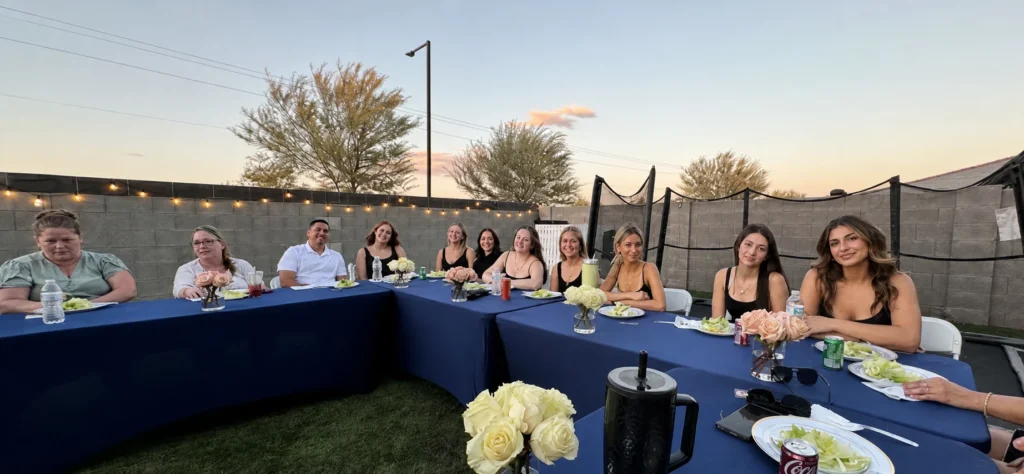 Guests seated at a blue table during a sunset hibachi dinner