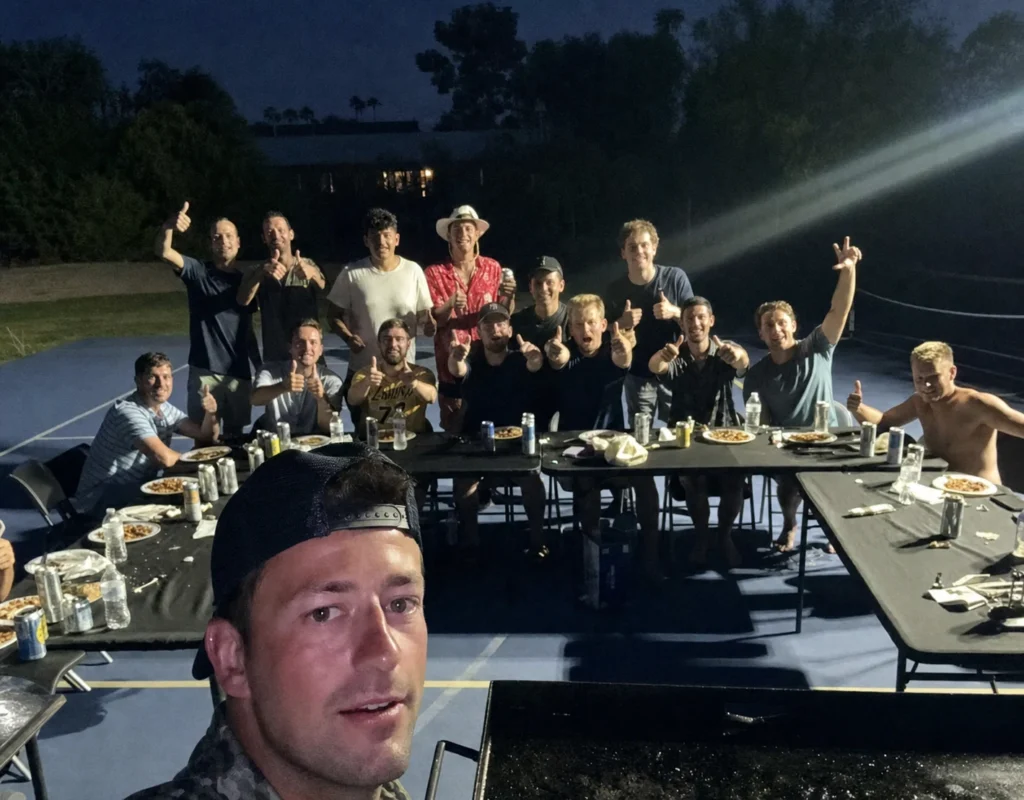 Friends taking a group selfie after a nighttime hibachi dinner