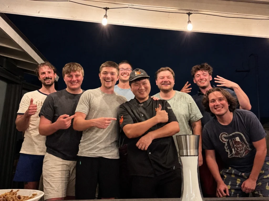 Hibachi chef posing with a group of friends
