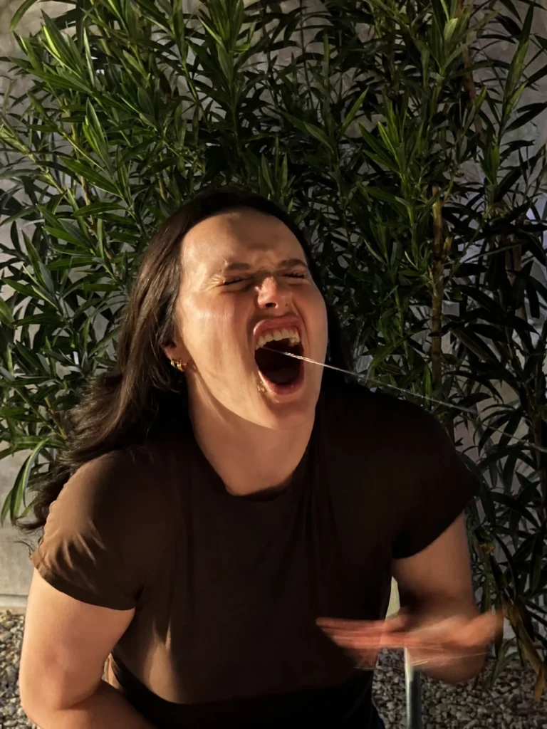Guest laughing during a sake-stream hibachi challenge