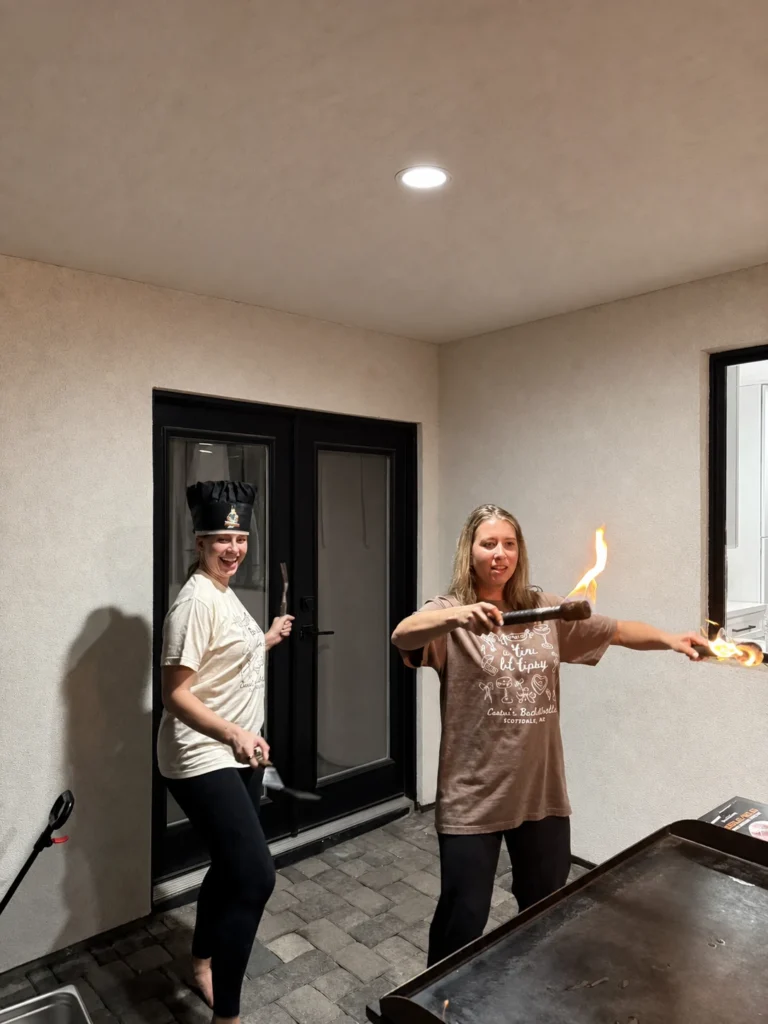Guests holding flaming utensils during hibachi entertainment