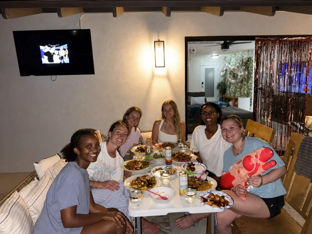 Friends enjoying an indoor hibachi dinner and water-gun game